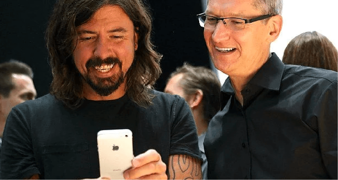 Dave Grohl and Tim Cook look at an iPhone.