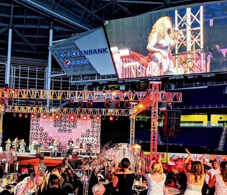 Gloria Gaynor and her band on stage at Marlins Park stadium with Gloria on the jumbo video screen.